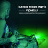 Angler using Foxelli green underwater fishing light at night from a boat to attract fish.