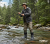 Man fly fishing in a forest stream with Foxelli Outdoor Gear wading boots.