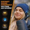 Woman in urban setting enjoying hi-res audio with Foxelli Bluetooth beanie.